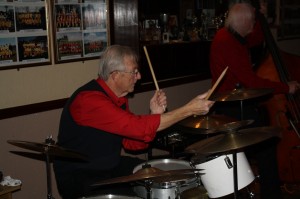 GRAHAM COLICOTT (drums) with MIKE BARRY'S UPTOWN BAND seen here at Farnborough Jazz Club, Kent, UK on 28th November 2014. Photo by Mike Witt.