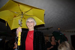 Ann takes part in the brolly parade ('Bourbon Street Parade'). George Tidiman's All Stars at Farnborough Jazz Club 19Dec2014. Photo by Mike Witt.