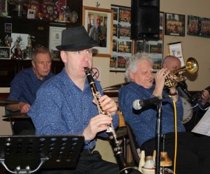 Mahogany Hall Stompers at Farnborough Jazz Club on 13th March 2015. (LtoR) Chris Walker (drums), Tim Huskisson (clarinet), Brian Giles (trumpet) & 'Southend Bob' Allbut (banjo). Photo by Mike Witt.