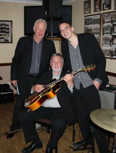 Brian Lawrence (d.bass &sousaphone), Julyan ‘Baby Jools' Aldridge (drums) & Jim Douglas (guitar &banjo) with Millenium Eagle Jazz Band at Farnborough Jazz Club, 15th May 2015. Photo by Mike Witt.