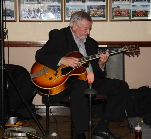 Jim Douglas (guitar &banjo) with Millenium Eagle Jazz Band at Farnborough Jazz Club, Kent on 15th May 2015. Photo by Mike Witt.