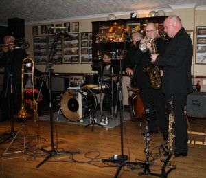 (LtoR) Terry Williams (trombone), Peter Brown (trumpet), Matt Palmer (clarinet) & Julyan ‘Baby Jools' Aldridge (drums) with Millenium Eagle Jazz Band at Farnborough Jazz Club on 15th May 2015. Photo by Mike Witt.