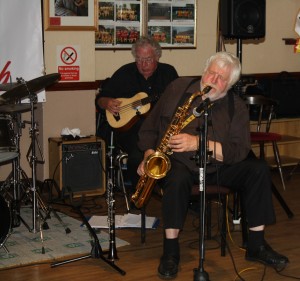 Peter Skivington (bass ukulele) and John Lee (tenor sax) playing with Laurie Chescoe's Reunion Jazz Band at Farnborough Jazz Club on 3rd July 2015. Photo by Mike Witt.