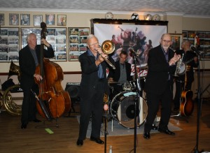 Millenium Eagle Jazz Band at Farnborough Jazz Club (Kent) on 24th July 2015. (LtoR) Brian Lawrence (double bass),Terry Williams (tombone), Julyan 'Baby Jools' Aldride (drums), Peter Brown (trumpet), David Moorwood (banjo) and missing from picture is band leader (reeds). Photo by Mike Witt.