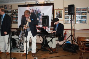 Mardi Gras JazzBand at Farnborough Jazz Club on 21st August 2016. (LtoR) Leigh Henson (trumpet), Rob Pierce (trombone) and Tim Huskisson (piano). Photo by Mike Witt.