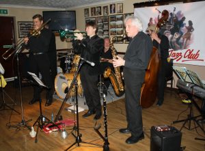 Phoenix Dixieland Jazz Band play for Farnborough Jazz Club on 23rd October 2015. (LtoR) Bill Todd (trombone), Paul Higgs (trumpet), Allan Clarke (drums), Charles Sherwood (clarinet) and Roger Curphey (double bass). (out of picture-John Steward (banj&guit) and Dave Barnes (piano). Photo by Mike Witt.
