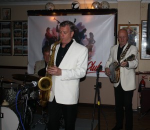 Tony Pitt's All Stars at Farnborough Jazz Club (Kent) on 9th October 2015. (LtoR) John Tyson (drums), Al Nichols (tenor sax) and Tony Pitt (banjo). Photo by Mike Witt.