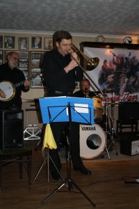 Bill Todd on trombone with Phoenix Dixieland Jazz Band at Farnborough Jazz Club on 22nd January 2016. (left John Stuart on banjo and right Alan Clarke on drums). Photo by Mike Witt.