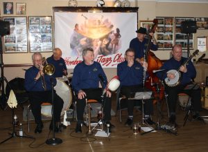 Golden Eagle Jazz Band at Farnborough Jazz Club (Kent) on 8th January 2016. (LtoR) Roy Stokes (trombone&vocs), Pete Jackman (drums), Mike Scroxton (trumpet), Alan Cresswell (clarinet), Mike Broad (double bass) and Band leader Kevin Scott (tenor banjo). Photo by Mike Witt.