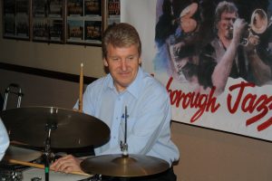John Tyson plays drums, one of Barry Palser's Super Six at Farnborough Jazz Club on 12th February 2016. Photo by Mike Witt.