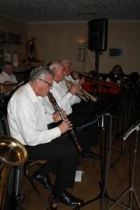 Lord Napier Hotshots play at Farnborough Jazz Club (Kent) on 26th February 2016. (LtoR) Lynn Saunders (banjo), Pat Glover (clarinet), Mike Jackson (trumpet) and Mike Duckworth (trombone). Photo by Mike Witt.