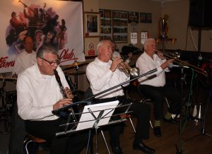 Lord Napier Hotshots play at Farnborough Jazz Club (Kent) on Friday 26th February 2016. (LtoR) Bill Traxler (drums) Pat Glover (clarinet), Mike Jackson, (trumpet), Lynn Saunders (banjo) and Mike Duckworth (trombone) (luv the yellow&black striped socks). [Mick Scriven (double bass & bass sax) is out of picture]. Photo by Mike Witt.