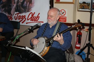'Southend Bob' Albutt playing banjo with Mahogany Hall Stompes at Farnborough Jazz Club (Kent) on 5th February 2016. Photo by Mike Witt.