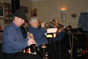Front line of Mahogany Hall Stompers. (LtoR) Tim Huskisson (clarinet), Brian Gyles (trumpe & band leadert) and George 'Kid' Tidiman at Farnborough Jazz Club (Kent) on 5th February 2016. Photo by Mike Witt.
