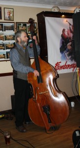 Roger Curphey (Bah Tat) on double bass here with his pint and with Mahogany Hall Stompers at Farnborough Jazz Club (Kent) on 5th February 2016. Photo by Mike Witt.