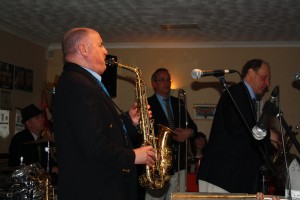 Lovely pic of John Ellmer on tenor sax with Tim Huskisson on piano, Rob Pearce on trombone and Leigh Henson on trumpet part of the Mardi Gras JazzBand at Farnborough Jazz Club (Kent) on 19th February 2016. Photo by Mike Witt.