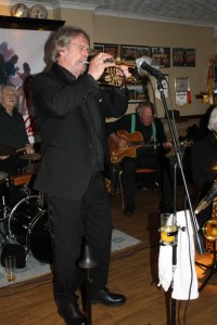 Allen 'Lord Arsenal' Bradley plays trumpet, backed by Laurie on drums and Pete on guitar with Laurie Chescoe's Reunion Band at Farnborough Jazz Club (Kent) on 22nd April 2016. Photo by Mike Witt.