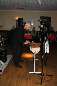 Colin Bray plays xylophone (Laurie watches on - seated) with Laurie Chescoe's Reunion Band at Farnborough Jazz Club on 22nd April 2016. Photo by Mike Witt.