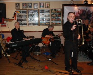 Laurie Chescoe's Reunion Band at Farnborough Jazz Club (Kent) on 4th September 2015. (LtoR) Colin Bray (piano), Jim Douglas (guitar/banjo), Mike Pointon (trombone), Laurie Chescoe (drums), Photo By Mike Witt.