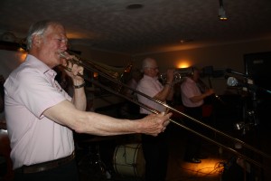 Front liners are Iain MCaulay (trombone), band leader Dave Stradwick (trumpet) and Bernard Stutt (clarinet) and engine are Pete Clancy-hidden (d.bass), Pete Lay (drums) and Phil Durrell (banjo) all playing as Sussex Jazz Kings for all at Farnborough Jazz Club (Kent) on 29th April 2016. Photo by Mike Witt.