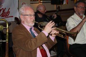 Band leader Bill Phelan, plays trumpet with Johnny McCallum on banjo and Alan Cresswell on clarinet with 'Bill Phelan's Muscrat Ramblers' at Farnborough Jazz Club (Kent) on 27th May 2016. Photo by Mike Witt.