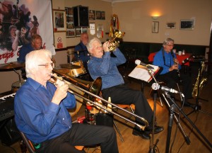 Mahogany Hall Stompers at Farnborough Jazz Club (Kent) on 20th May 2015. (LtoR) Colin Graham (trombone), Chris Marchant (drums), Brian Gyles (band leader & trumpeter), 'Southend Bob' Albutt (banjo), tony Teale (clarinet) and not in picture - Roger Curphey (double bass) and Tim Huskisson (piano). Photo by Mike Witt.