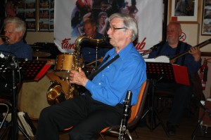 Mahogany Hall Stompers at Farnborough Jazz Club (Kent) on 20th May 2015. (LtoR) Band leader Brian Gyles (trumpet), Chris Marchant (drums), Tony Teale (tenor Sax) and 'Southend Bob' Albutt (banjo). Photo by Mike Witt.