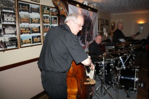 What about the 'Engine' too - of 'Tony Pitt's All Stars' seen here at Farnborough Jazz Club (Kent) on 6th May 2016. (LtoR) Andy Laurence (d.bass), John Ellmer (drums) and Tony Pitt (Band Leader & banjo) Photo by Mike Witt.