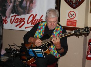 Doug Parry plays guitar for Dave Rance's Rockin' Chair Band at Farnborough Jazz Club (Kent) on Friday 10th June 2016. Photo by Mike Witt.
