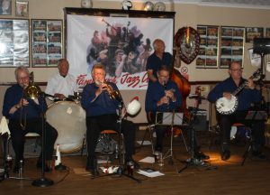 Golden Eagle Jazz Band play at Farnborough Jazz Club (Kent) on Friday, 17th June 2016. (LtoR) Roy Stokes (trombone), Pete Jackman (drums), Mike Scroxton (trumpet), Alan Cresswell (clarinet), Mike Broad (d.bass) and band leader Kevin Scott (tenor banjo). Photo by Mike Witt.