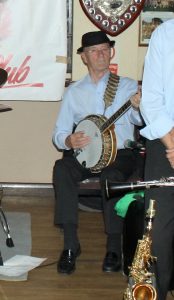 Tony Pitt, playing banjo as one of 'Barry Palser's Super Six, here at Farnborough Jazz Club (Kent) on 15th July 2016. Photo by Mike Witt.