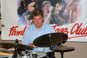 John Tyson playing drums, as one of 'Barry Palser's Super Six', here at Farnborough Jazz Club (Kent) on 15th July 2016. Photo by Mike Witt.