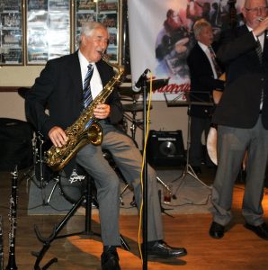John Crocker plays tenor sax, Mike Cotton on trumpet and Murray Salmon on double bass, with Jackie Free's Chicagoans at Farnborough Jazz Club (Kent) on 5th August 2015. Photo by Mike Witt.