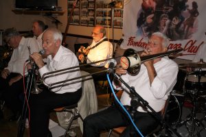 Lord Napier Hotshots play at Farnborough Jazz Club (Kent) on Friday, 29th July 2016. (LtoR) Pat Glover (clarinet), Mick Scrivens (bass sax. (trumpeter Mike Jackson sings and John Stewart banjo), Mike Duckworth (trombone) and Bill Traxler's drums.. Photo by Mike Witt.