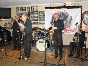 Tony Pitt's All Stars came to Farnborough Jazz Club for Keith's birthday on 12th August 2016. (LtoR) Dave Hewitt (trombone), (hidden) Andy Lawrence (double bass), Alan Gresty (trumpet), (hidden) John Ellmer (drums), Al Nichols (tenor sax) and Tony Pitt (banjo). Photo by Mike Witt.