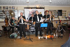 The Fenny Stompers play at Farnborough Jazz Club's 'Battle of Brittain' Anniversary fancy dress party on 16th September 2016. (LtoR) Dave Arnold (Sousaphone), Dennis Vick (clarinet), Ken Joiner (drums), Dave Marchant (trumpet), Brian Vick (banjo) and John Lee (trombone). Photo by Mike Witt.
