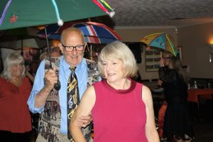 Penny and Bob take part in the brolly parade to 'Bourbon Street Parade' by The Fenny Stompers Jazz Band at Farnborough Jazz Club's 'Battle of Britain' Anniversary fancy dress party on 16th September 2016. Photo by Mike Witt.